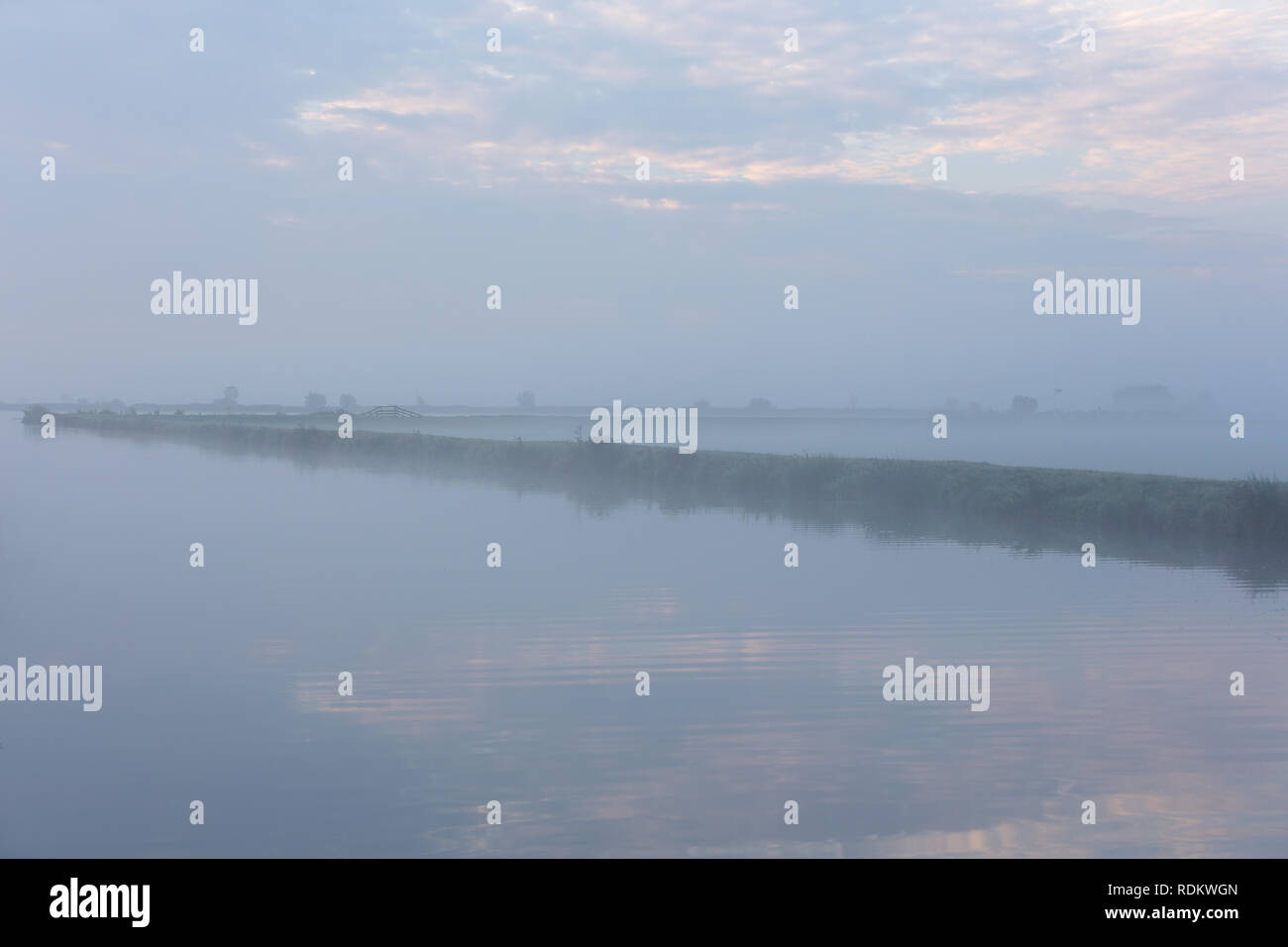 A foggy morning water landscape of the Norremeer of the Kagerplassen in South-Holland The Netherlands. Stock Photo