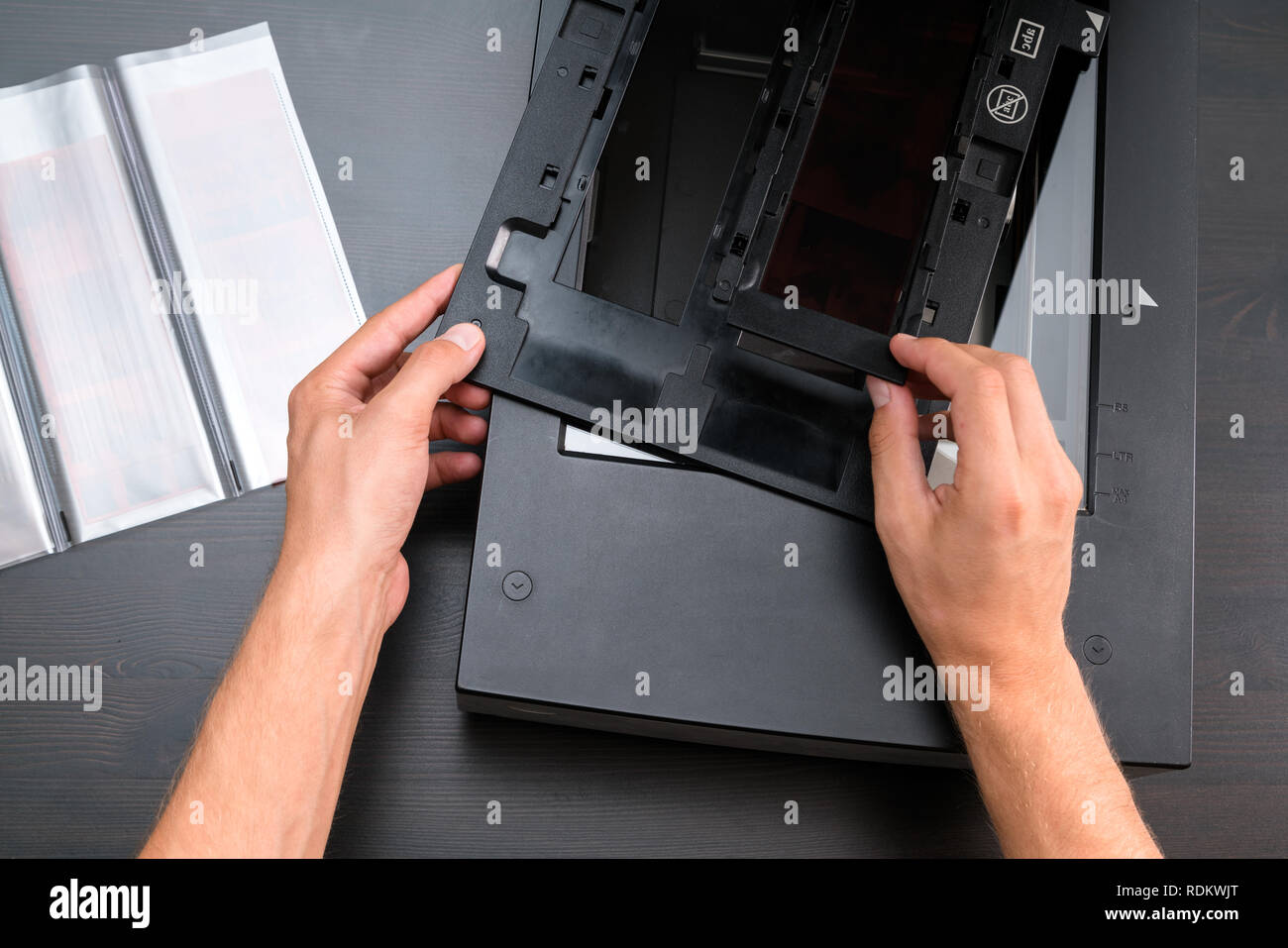 Professional technician hand scanning negative film and slides