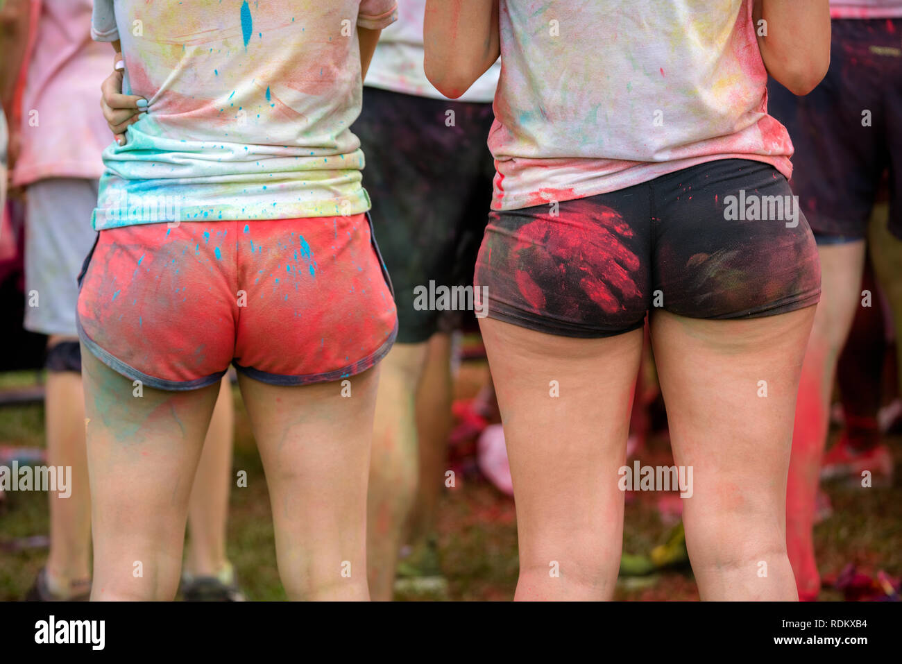 Girls in bikini shorts with a red hand mark on butt cheek. Fun and