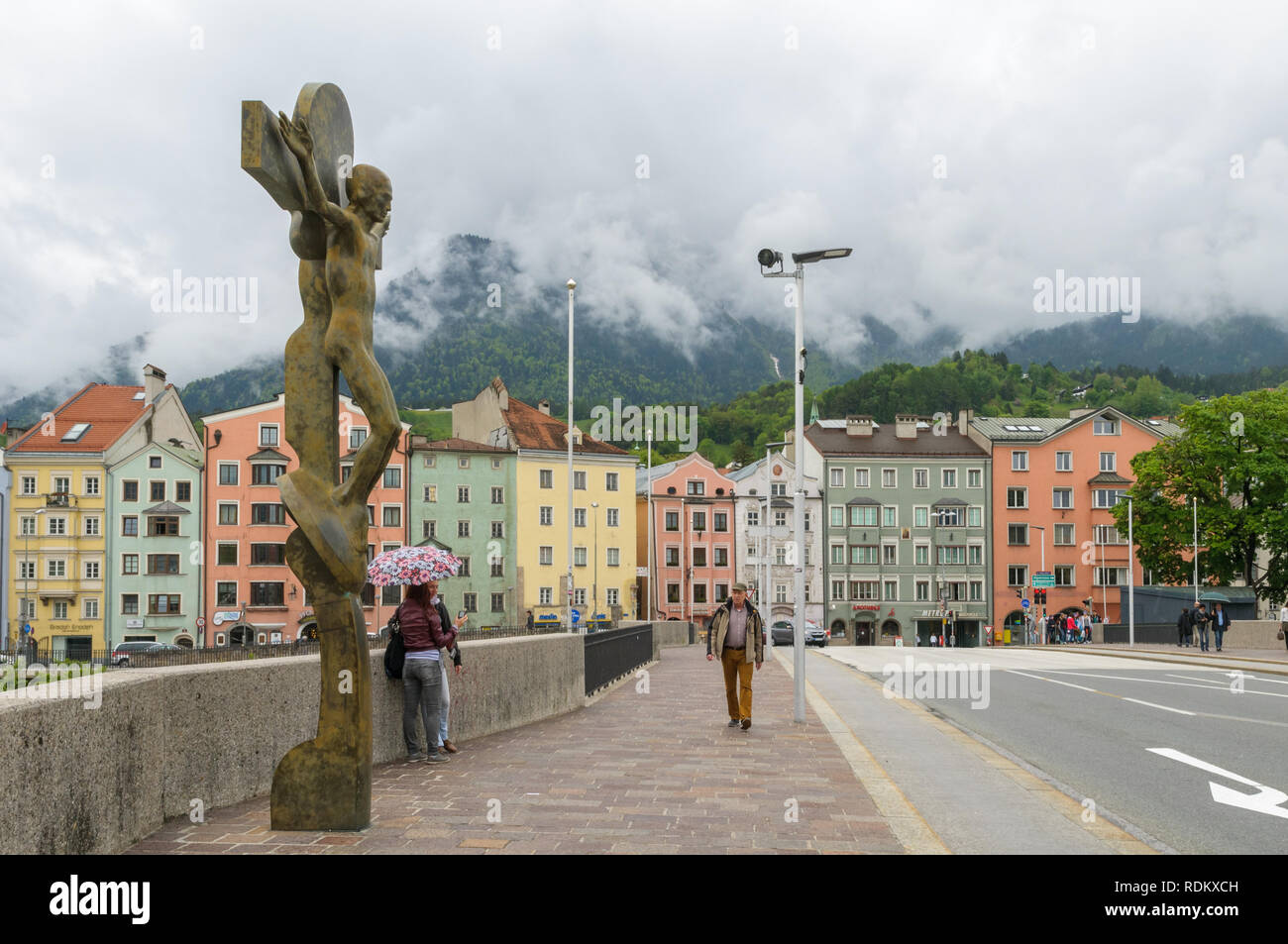 INNSBRUCK, AUSTRIA - MAY 11, 2013: The crucifix by Rudi Wach on the bridge across the river Inn near the historic town centre of Innsbruck, Austria. T Stock Photo