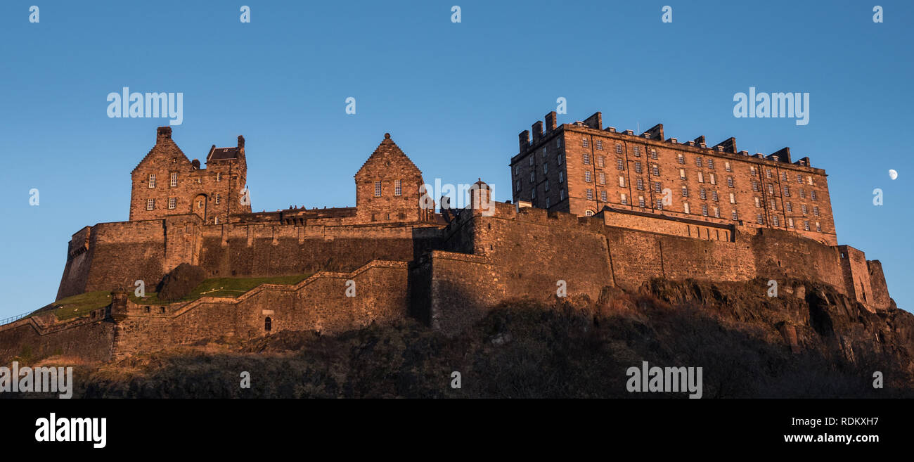 Edinburgh Castle, Scotland on a winter's evening with moon in the sky. Stock Photo