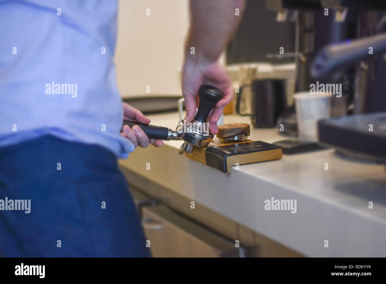 Hipster barista using tamper making perfect fresh professional cup of coffee Stock Photo