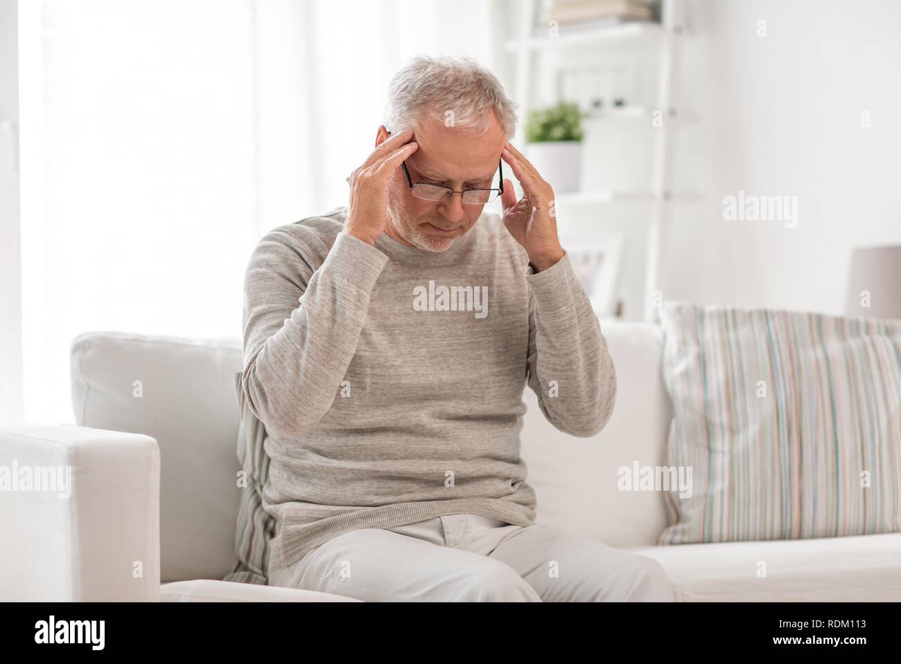 senior man suffering from headache at home Stock Photo - Alamy