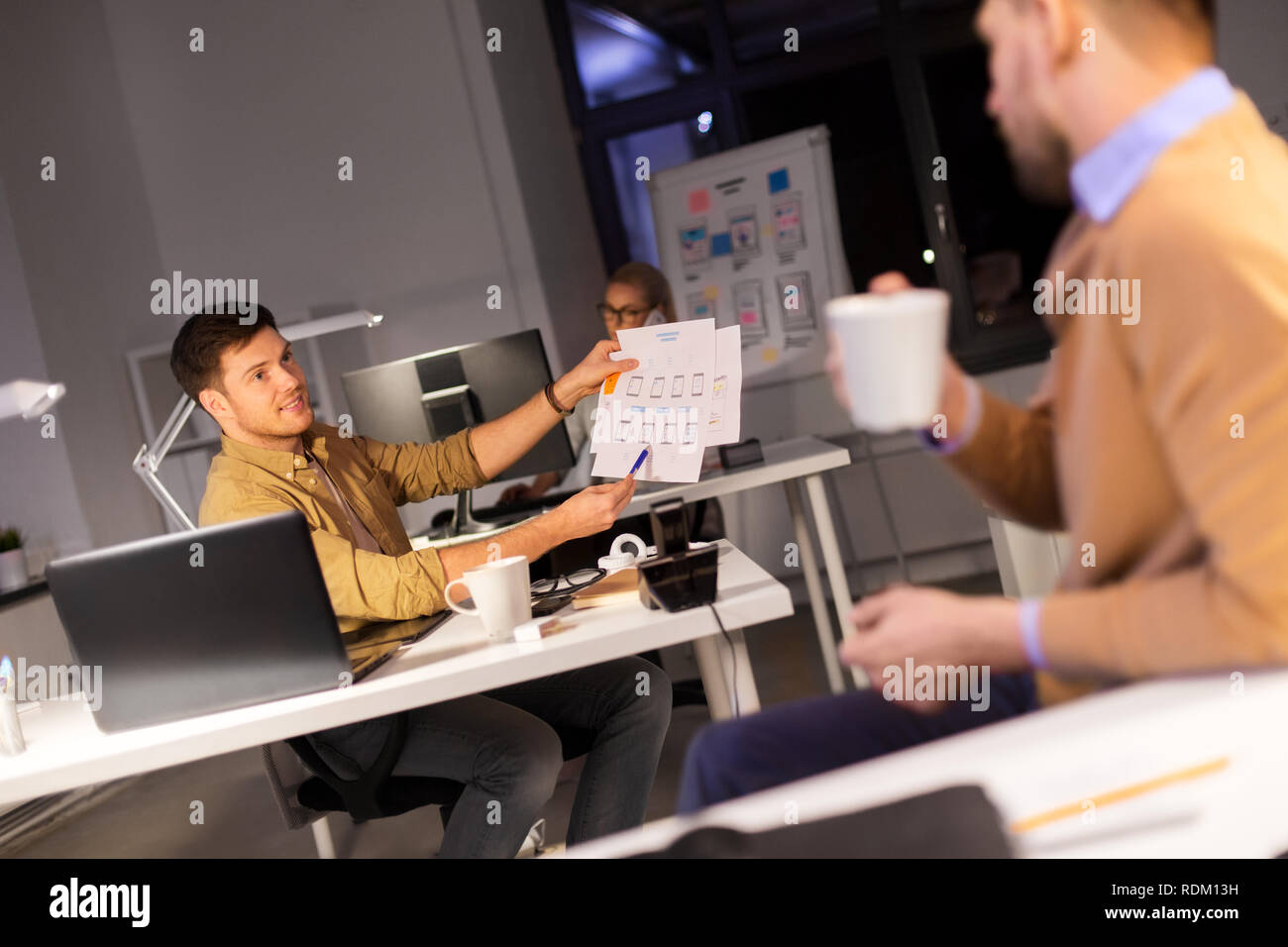 designers or software developers at night office Stock Photo