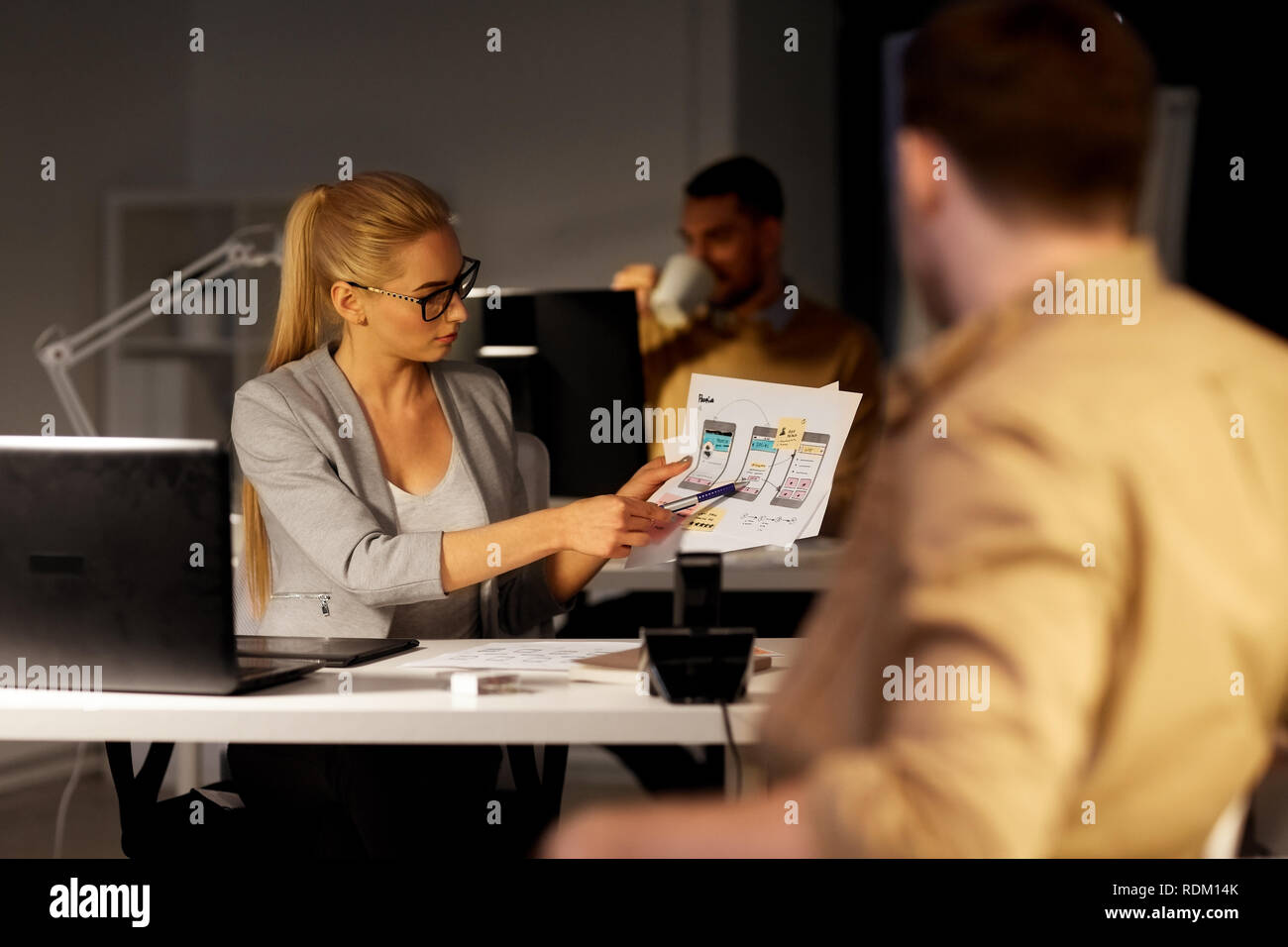 workers with user interface mockup at night office Stock Photo