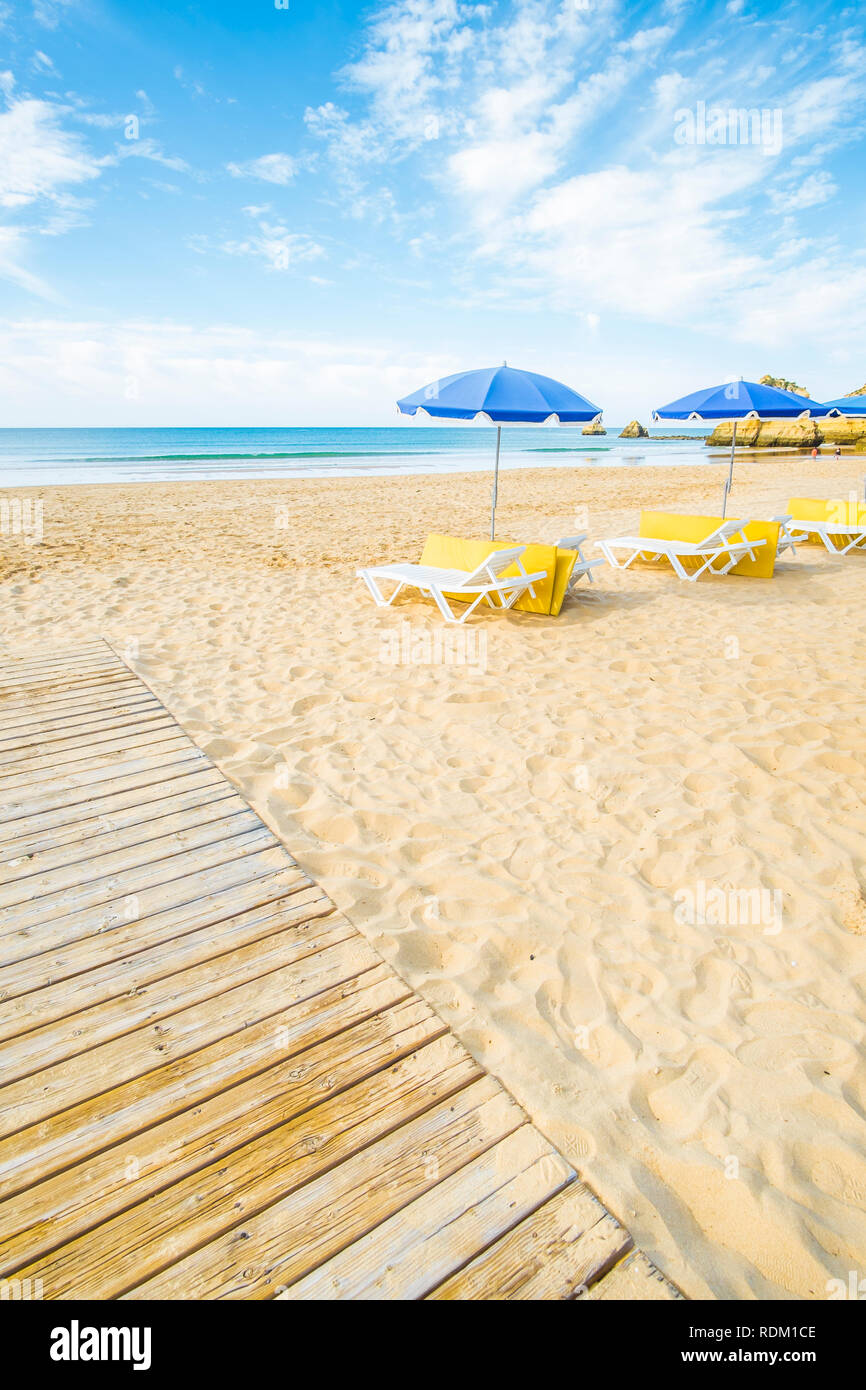 umbrellas and beach chairs at deserted beach in pre-season Stock Photo