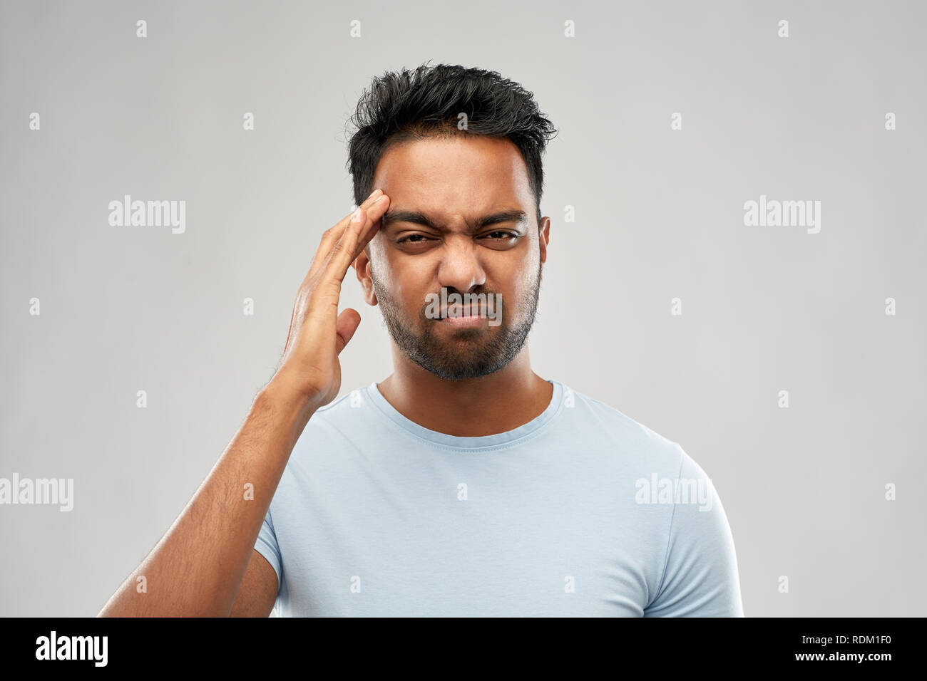 unhappy indian man suffering from headache Stock Photo - Alamy