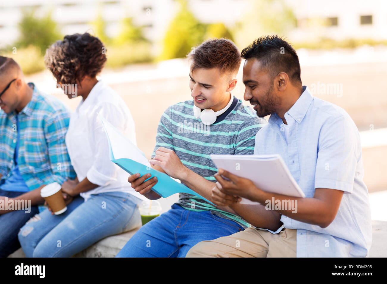international students with notebooks outdoors Stock Photo