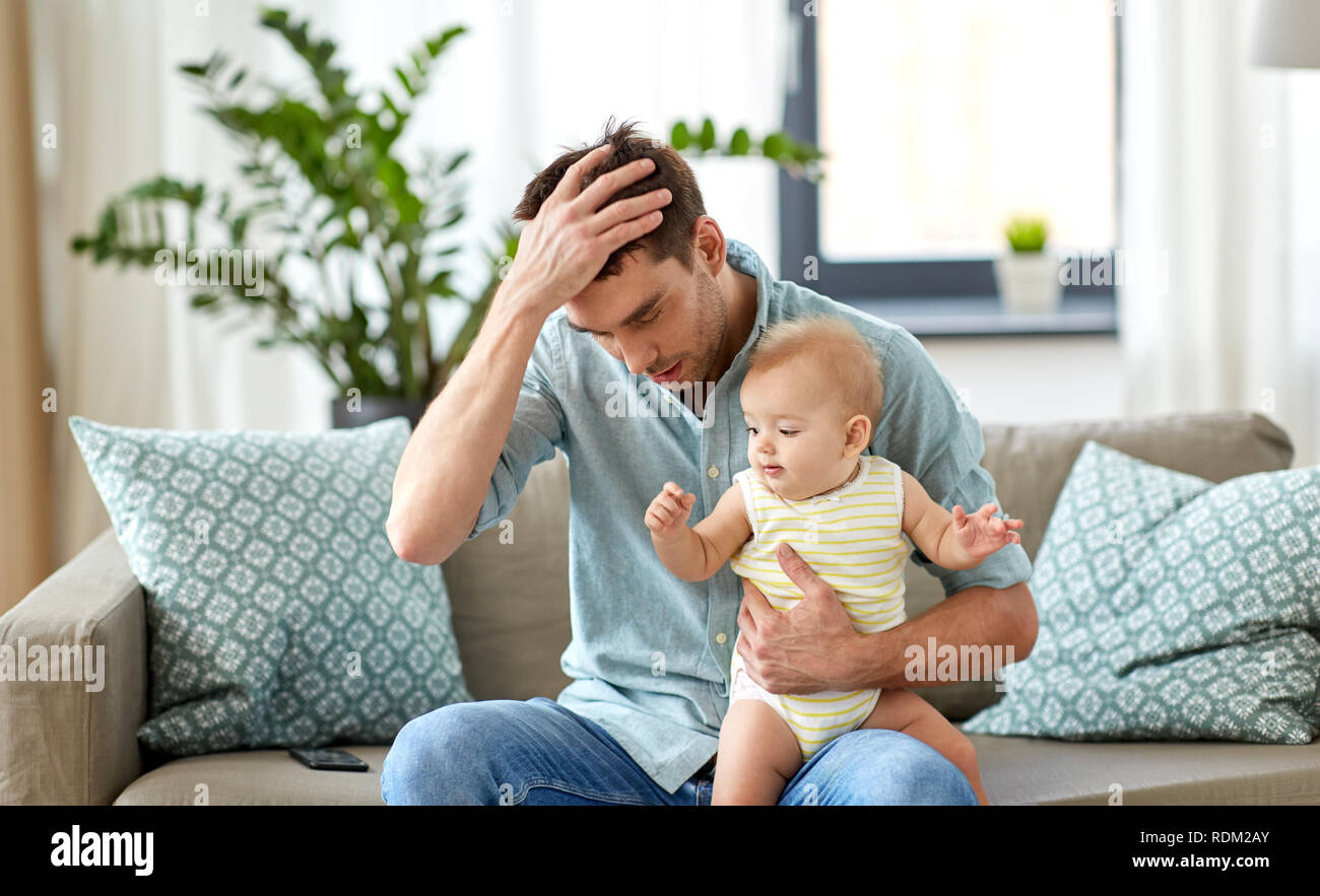 despaired father with little baby daughter at home Stock Photo