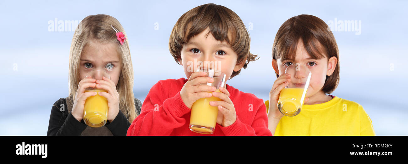 Group of children girl boy kids drinking orange juice healthy eating banner young Stock Photo
