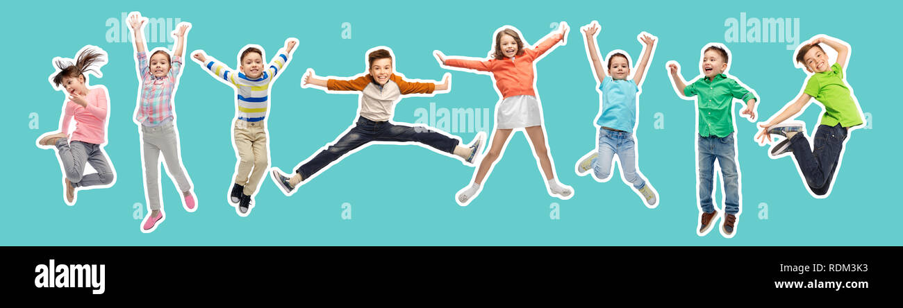 happy kids jumping in air over blue background Stock Photo