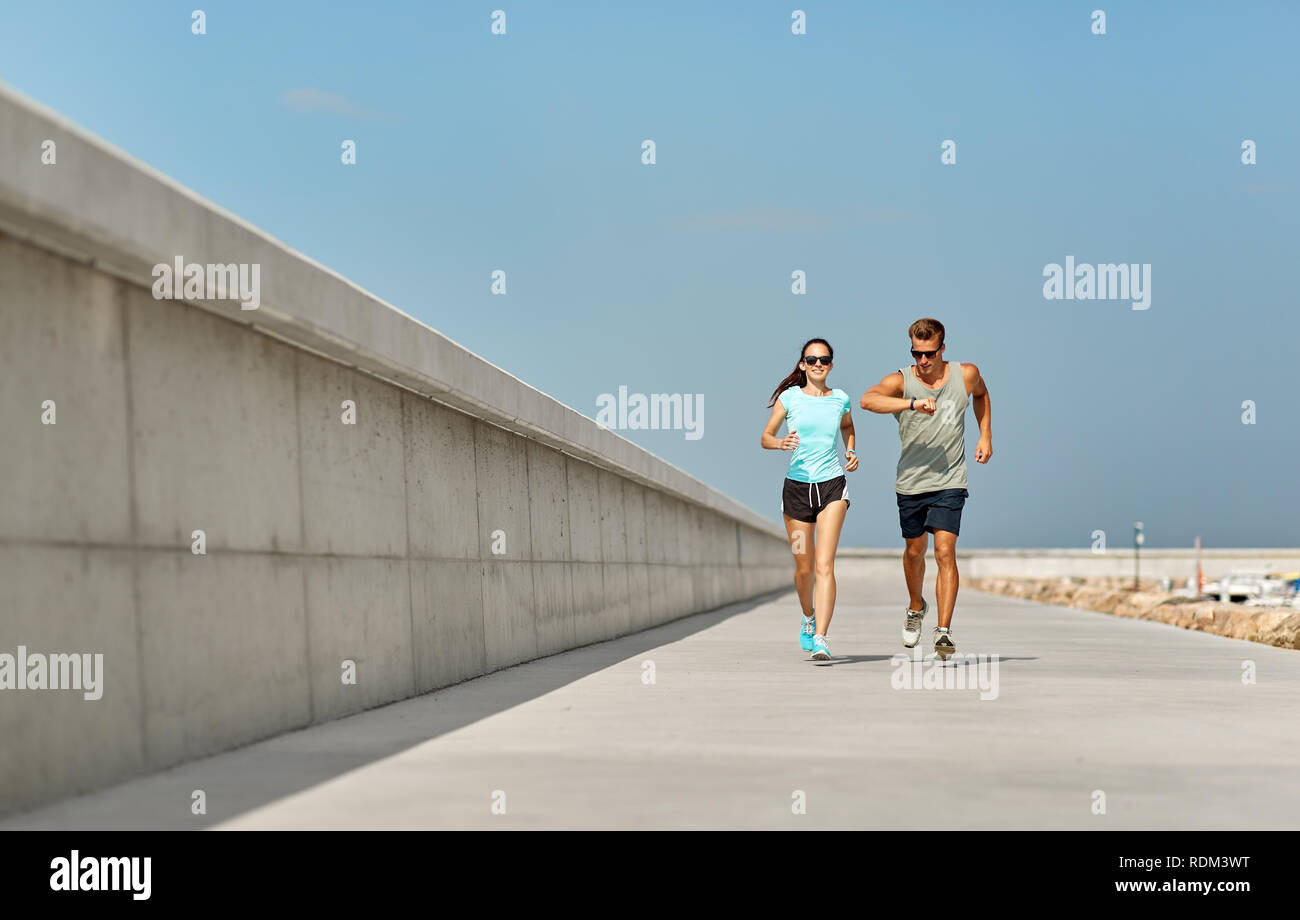 couple in sports clothes running outdoors Stock Photo - Alamy