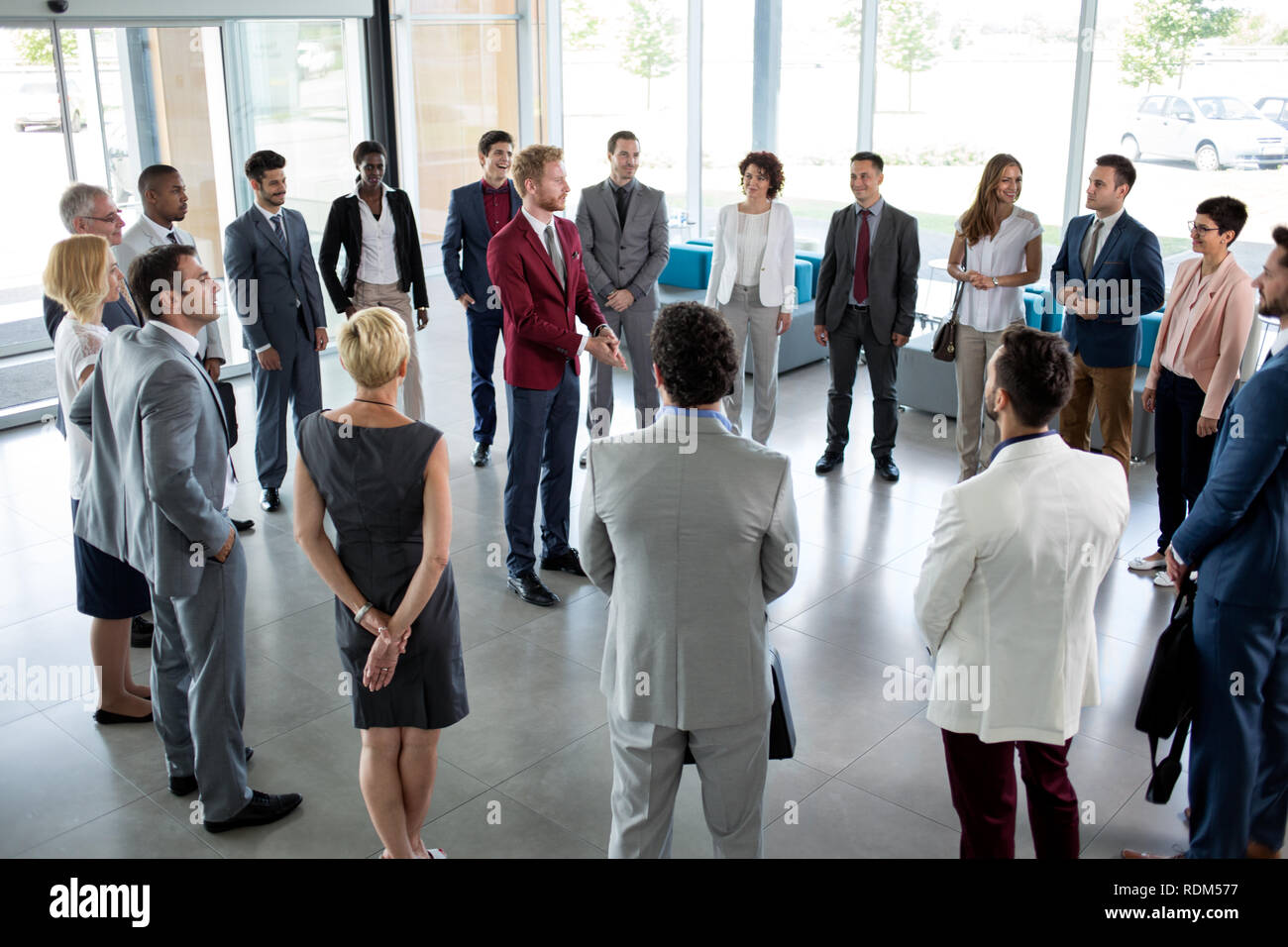 young leader standing in circle of his successful business team Stock ...