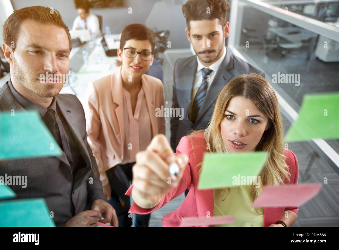 Creative business team organization at sticky notes on window Stock Photo