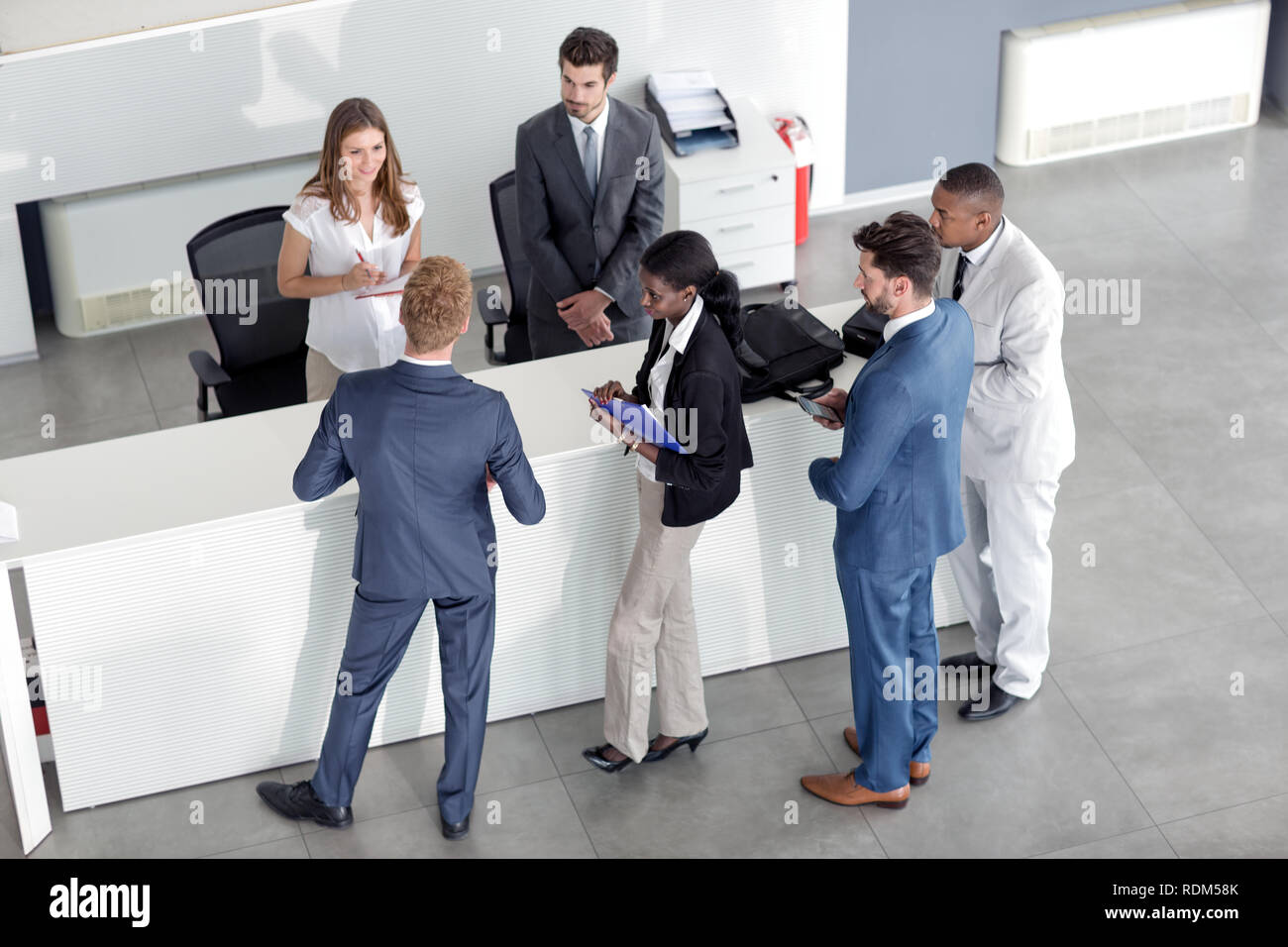 professional business people checking at reception desk Stock Photo Alamy