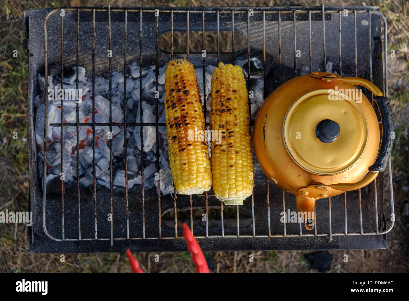 Vinatage Copper Teapot and sweet corn on the Grill Stock Photo