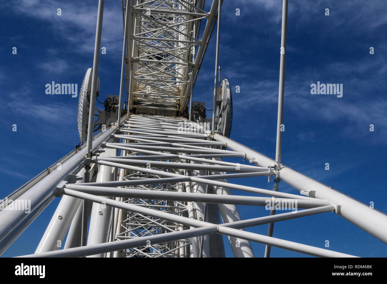 Seattle Big Wheel jumbo ferris wheel view from inside car looking up the white spokes to a blue sky with clouds Stock Photo