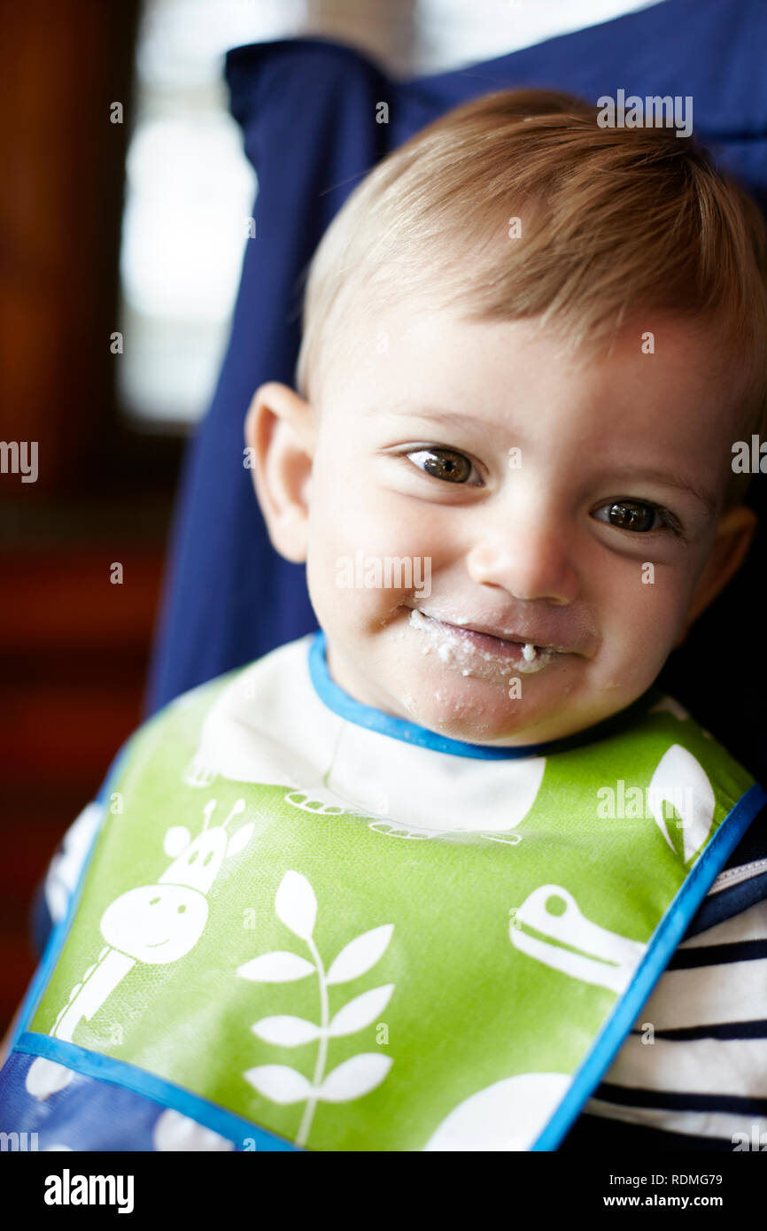 Portrait of baby boy in high chair Stock Photo Alamy