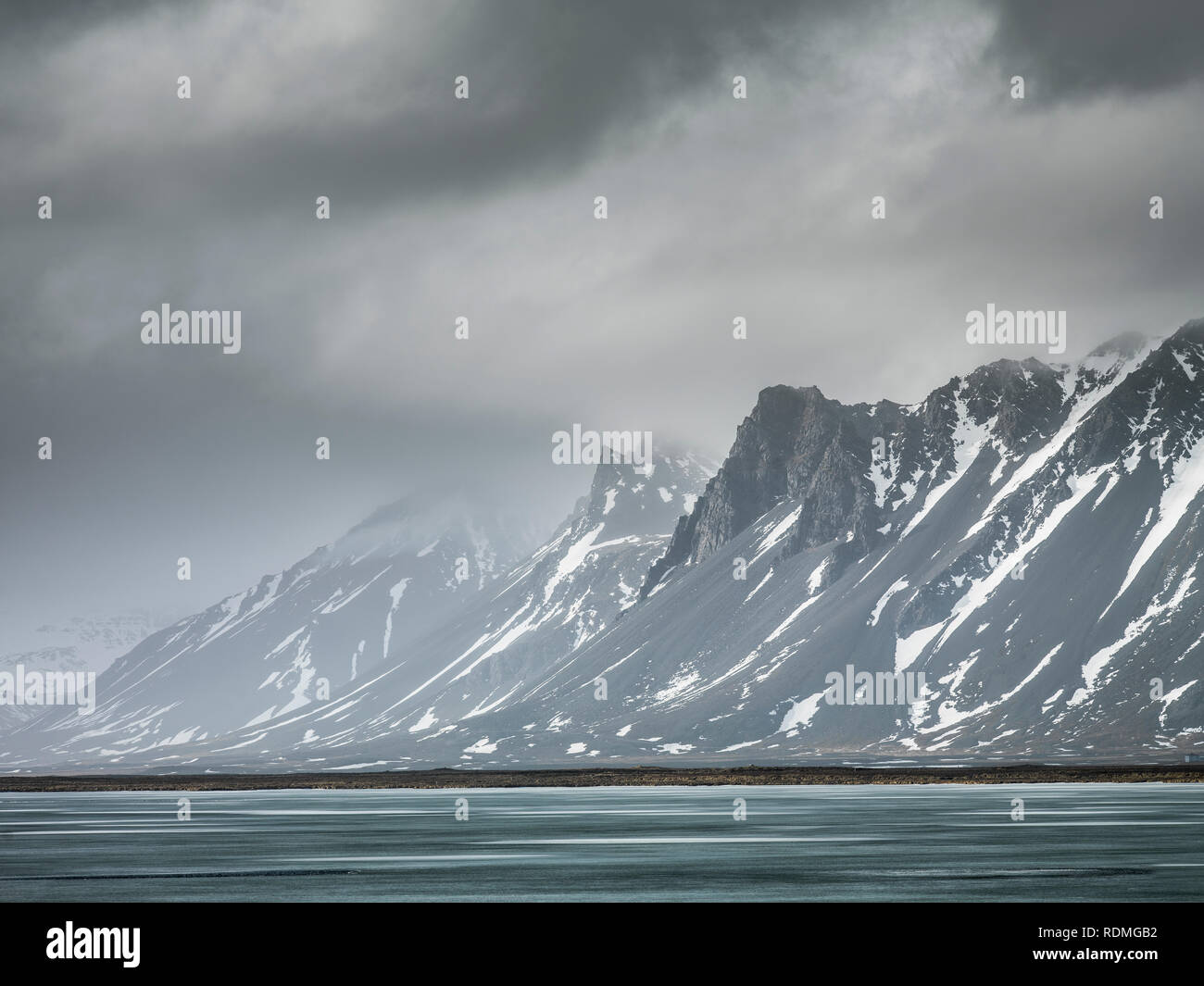 Storm clouds over mountains and lake Stock Photo - Alamy