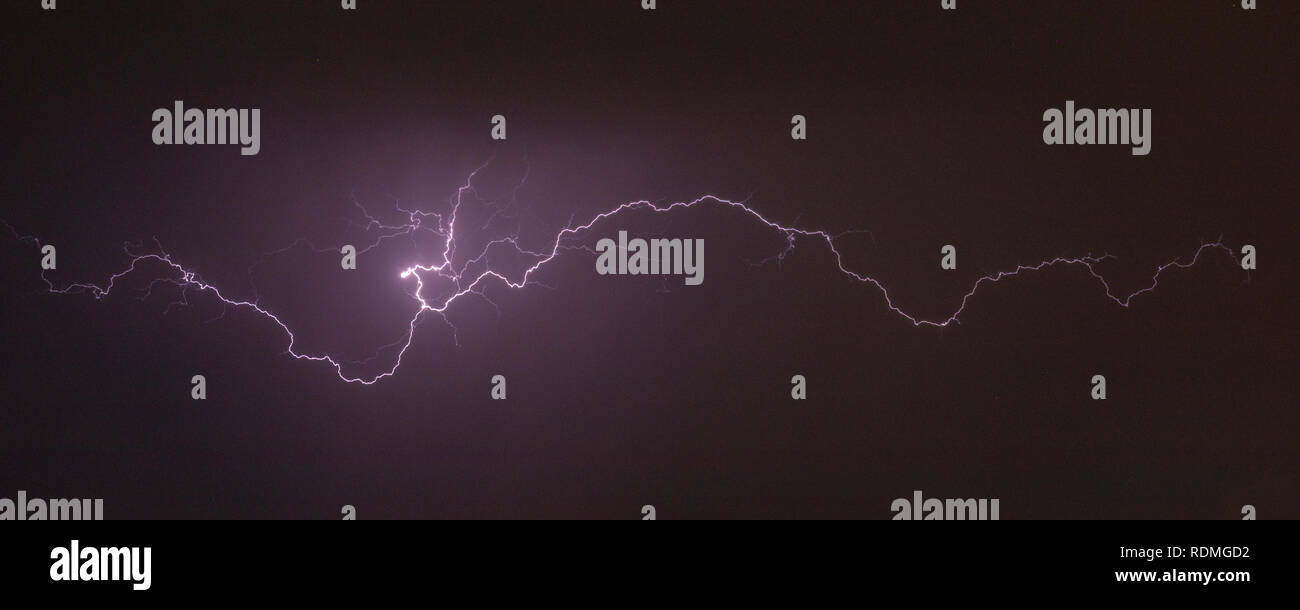 Cloud to Air Lightning at Night with a Purple Hue Stock Photo