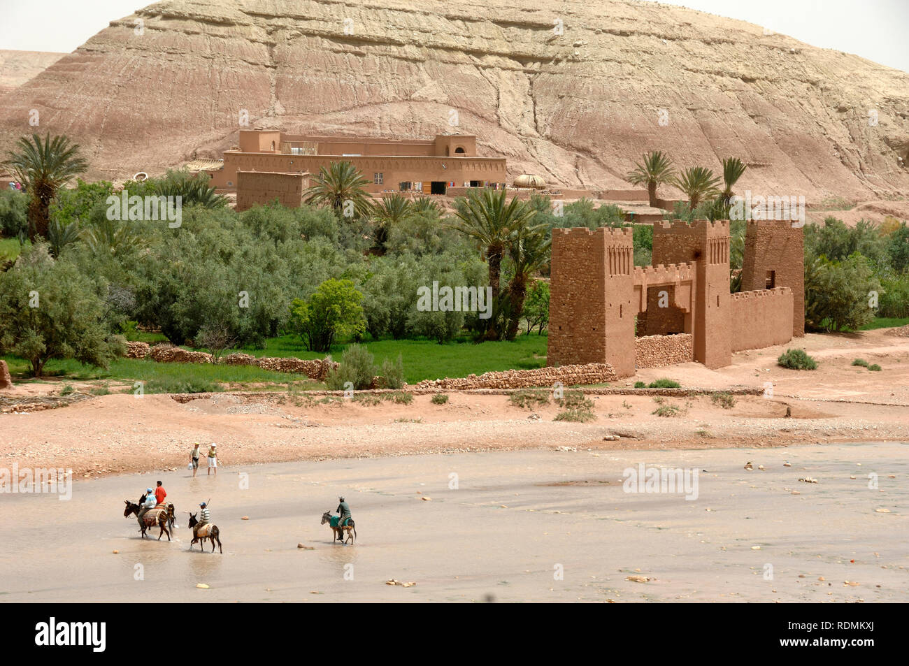 Tourists Visiting Ksar of Aït-Ben-Haddou aka Ait Benhaddou, an Adobe Earth Clay Built Fortified Village or Ighrem, and Popular Film Location Morocco Stock Photo