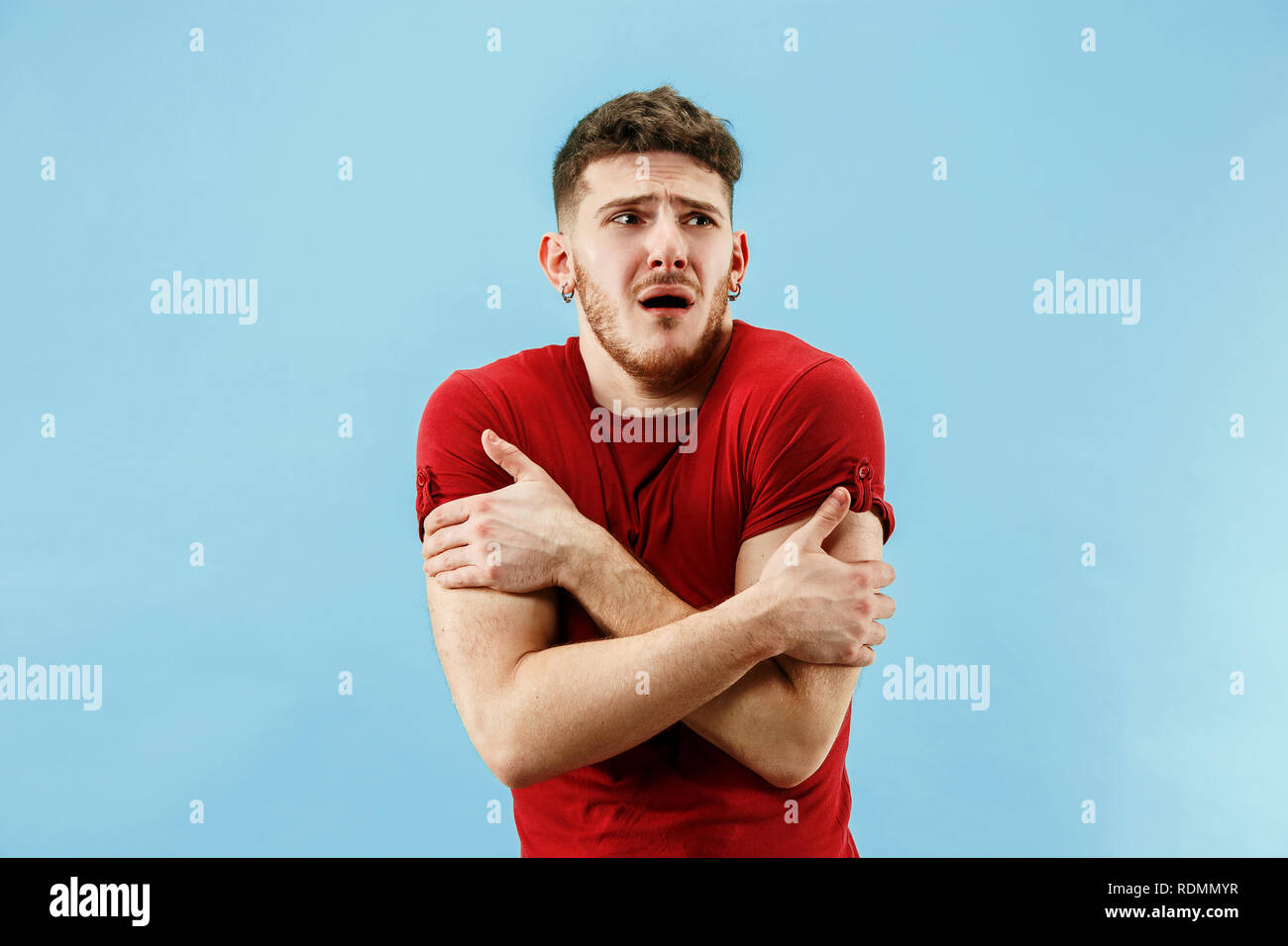 Young boy with a surprised unhappy failure expression bet slip on blue ...