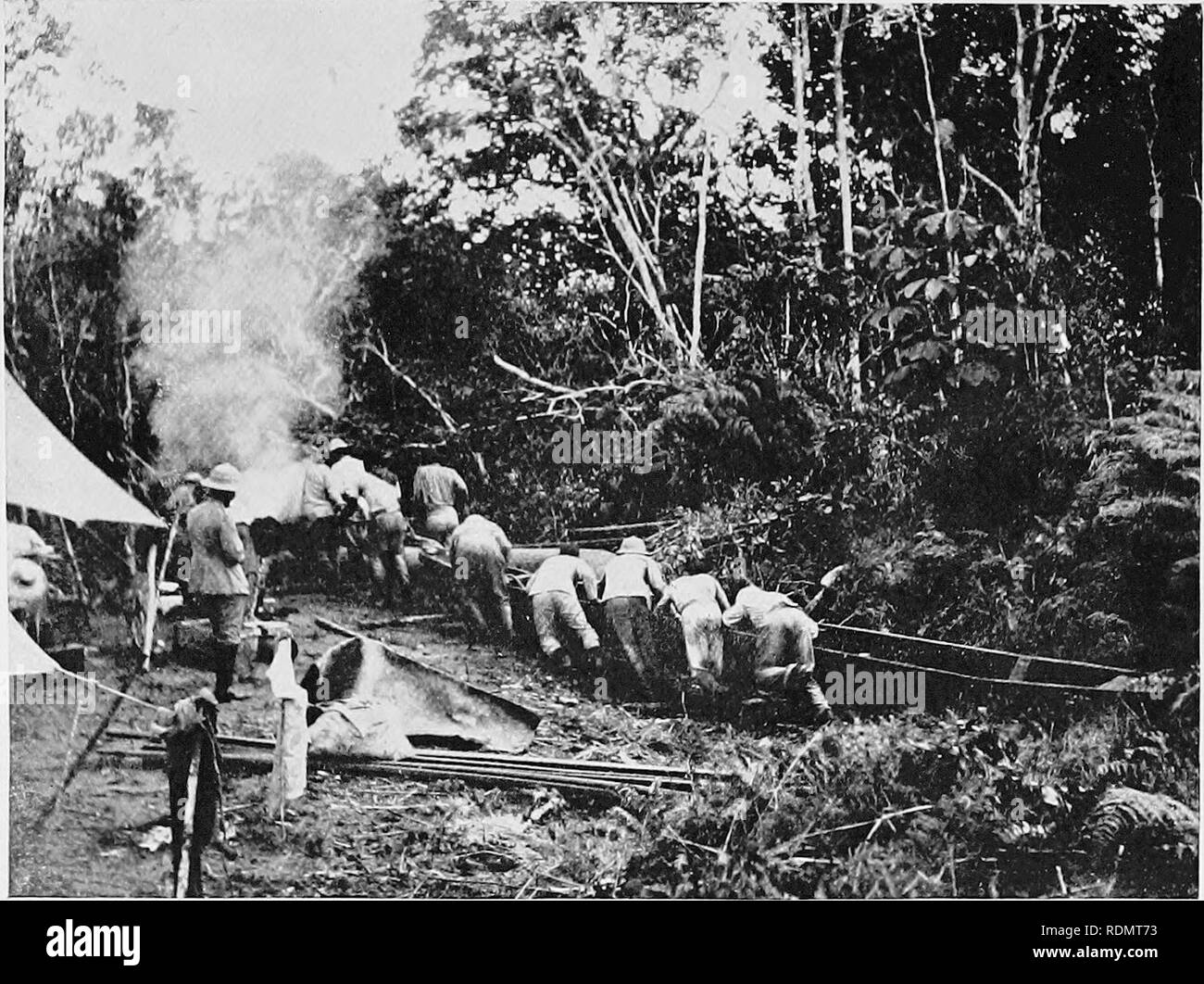 Through the Brazilian wilderness . Roosevelt-Rondon Scientific Expedition  (1913-1914); Zoology. Manner of dragging the canoes across a hilly portage  From a pkotograpk by Cherrie. Please note that these images are extracted
