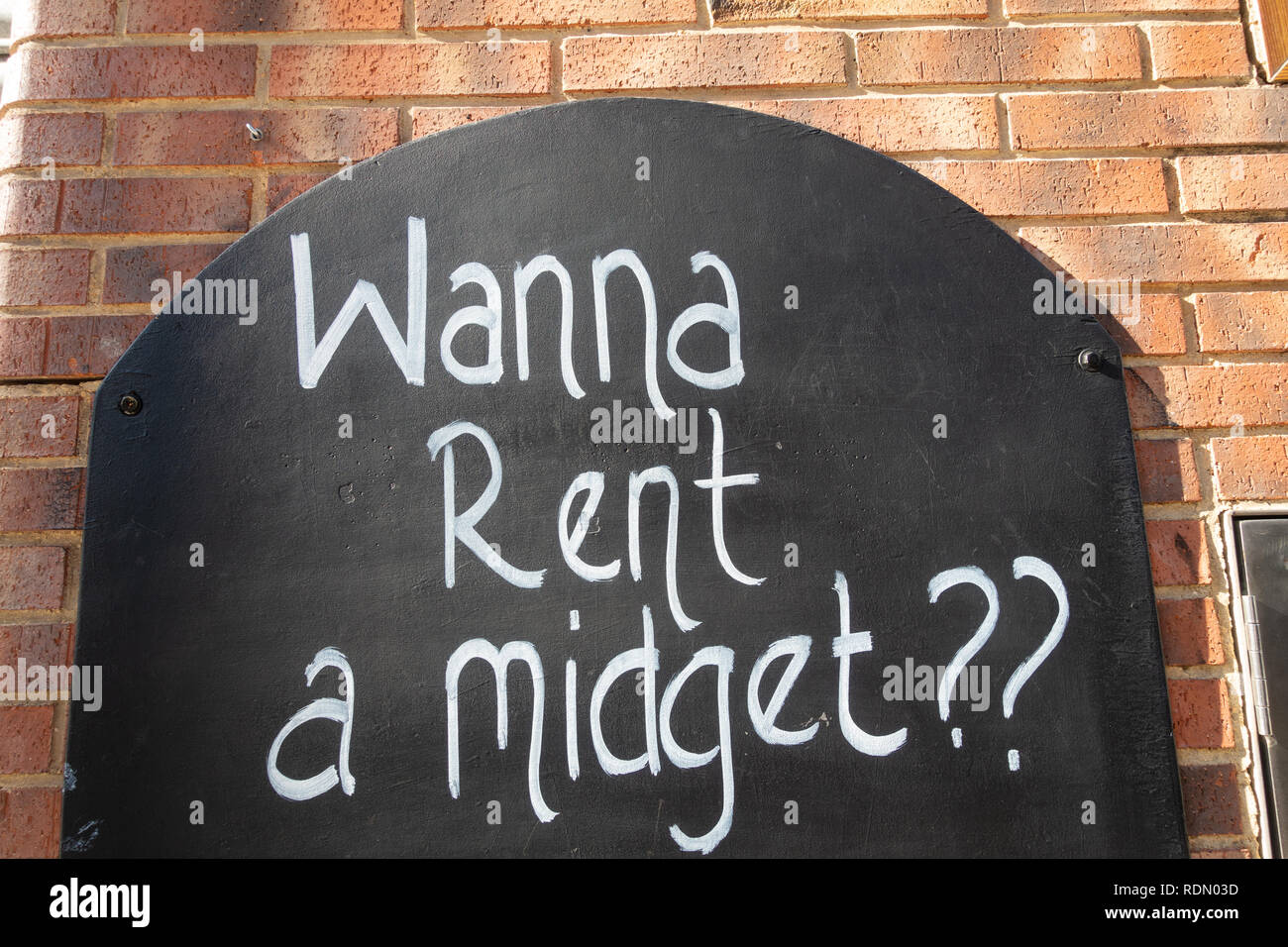 Wanna rent a midget, sign outside a nightclub in Benidorm, Costa Blanca, Spain Stock Photo