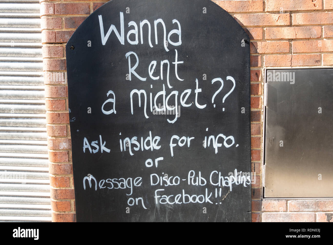 Wanna rent a midget, sign outside a nightclub in Benidorm, Costa Blanca, Spain Stock Photo
