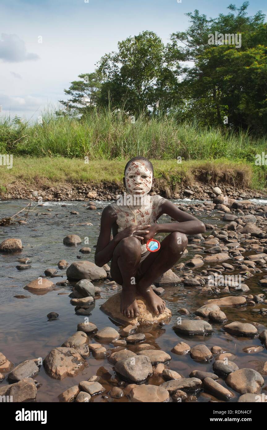 Surma boy with facial and body painting, Kibish, Omo River Valley, Ethiopia, Africa Stock Photo