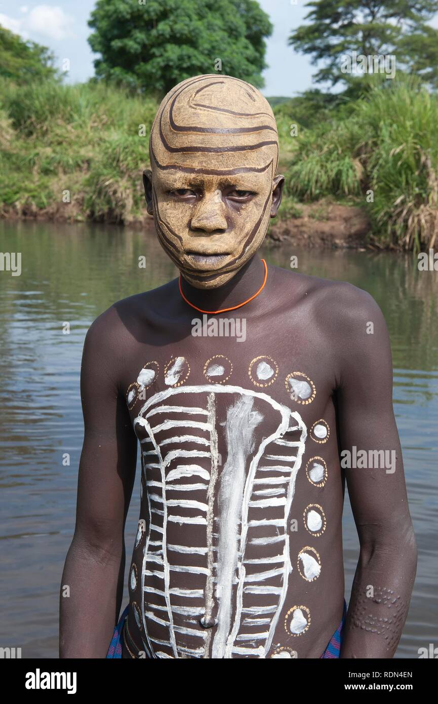 Surma boy with facial and body painting, Kibish, Omo River Valley, Ethiopia, Africa Stock Photo