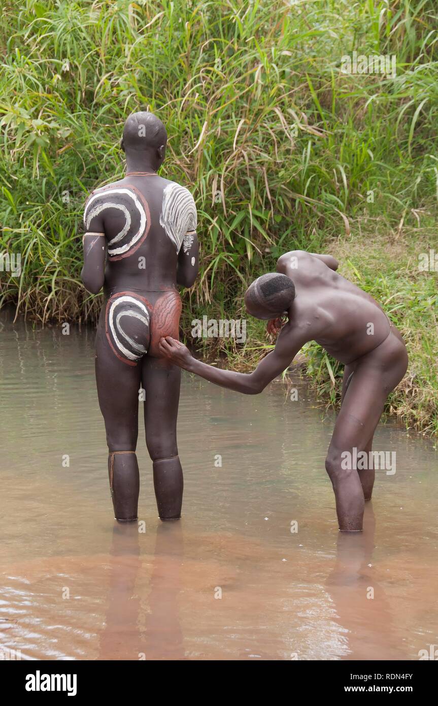 Before the Donga stick fight, the Surma warriors apply a body paint made of clay and minerals on their bodies, Surma tribe Stock Photo