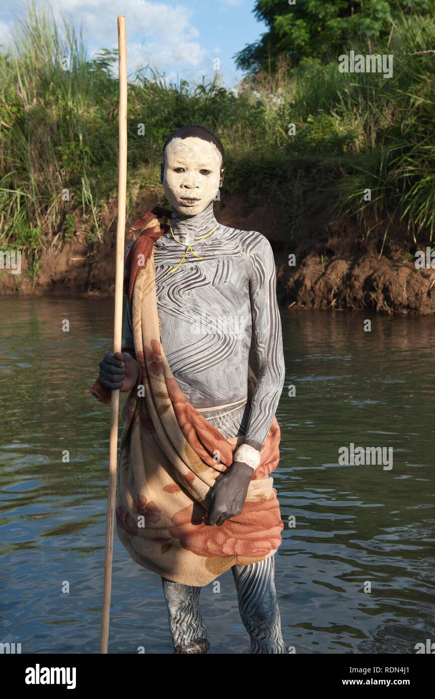 Surma boy with facial and body painting, Kibish, Omo River Valley, Ethiopia, Africa Stock Photo