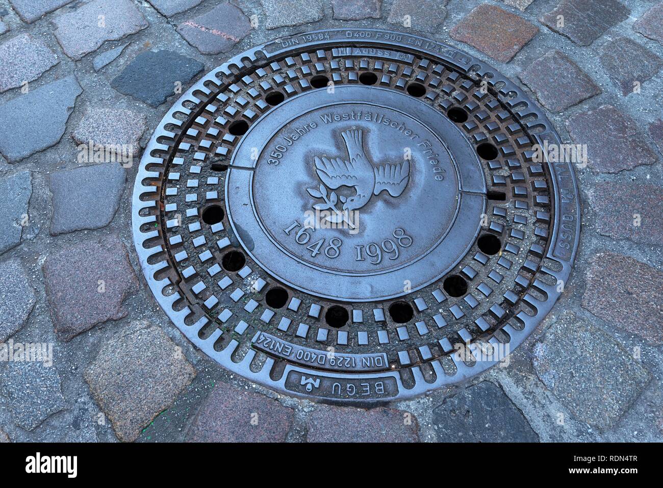 Manhole cover with the motive of a dove of peace, symbol Westphalian peace, Münster, North Rhine-Westphalia, Germany Stock Photo