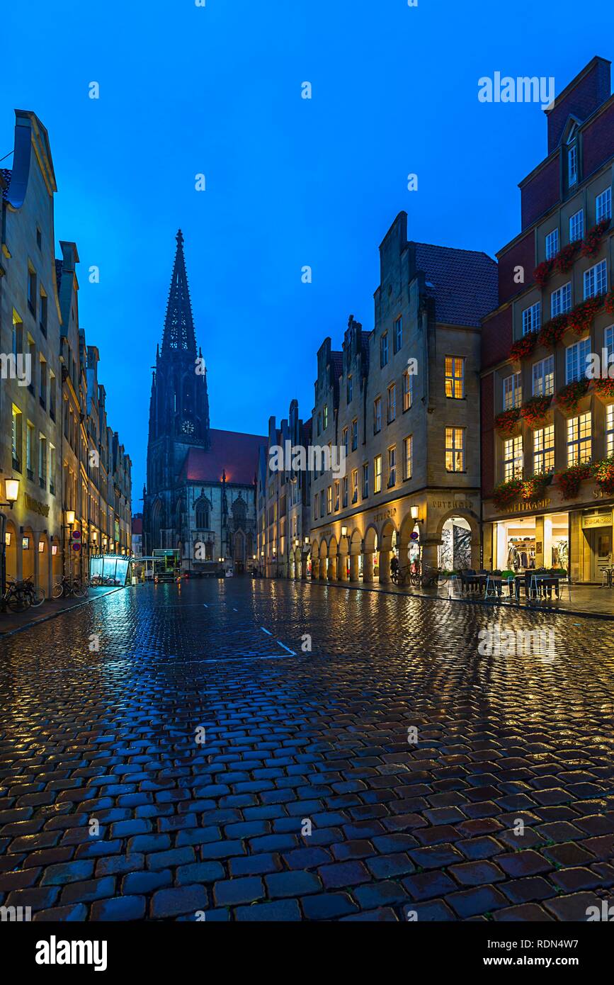 Arcades and historic gabled houses in the rain and at dusk, Lambertikirche at the back, Prinzipalmarkt, Münster Stock Photo