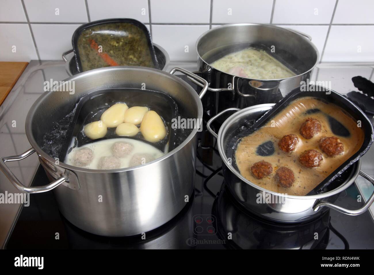 Heating prepared meals in a water bath Stock Photo