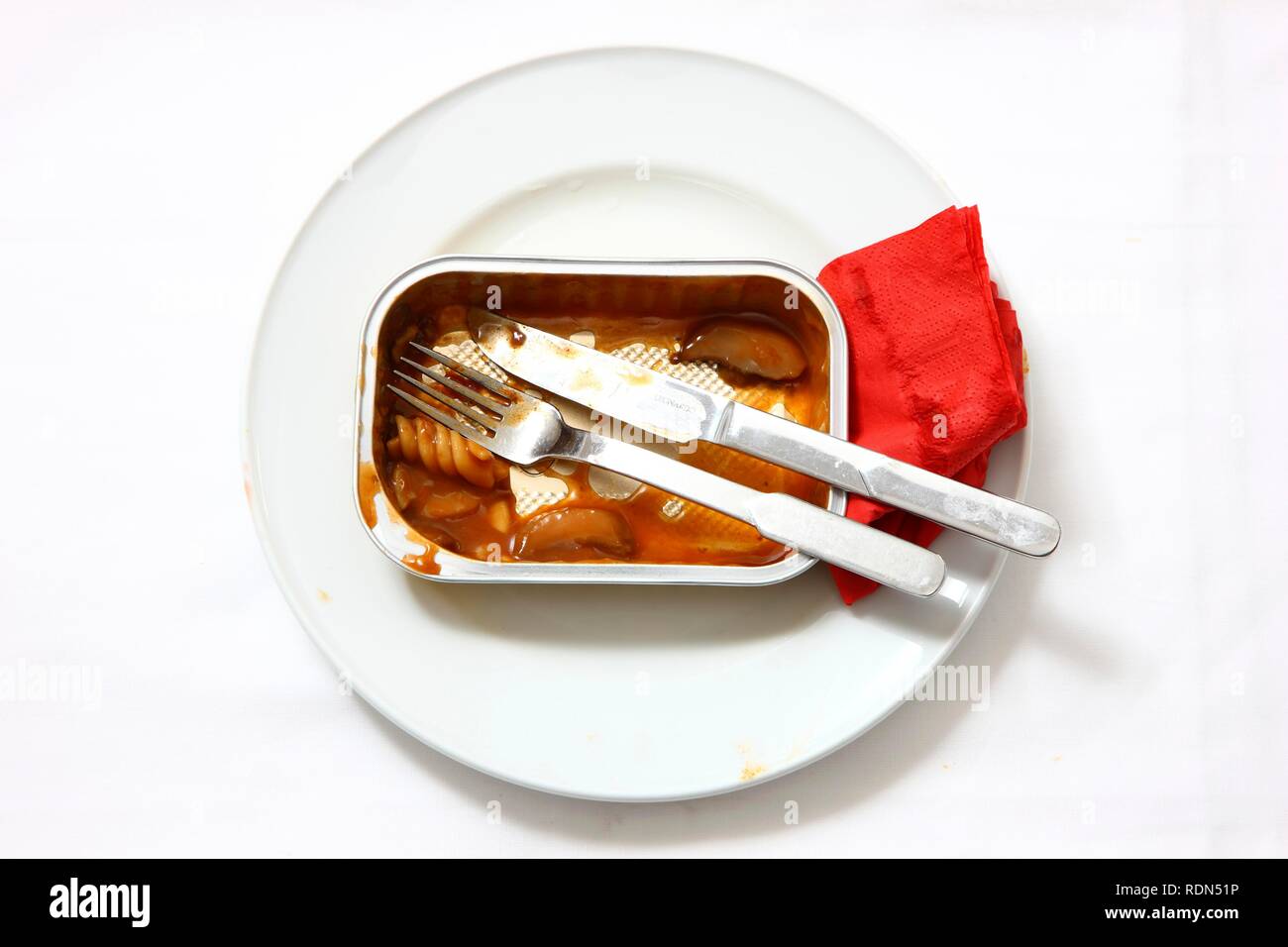 Remains of a pre-prepared meal after being eaten, served on a plate, in the original packaging Stock Photo