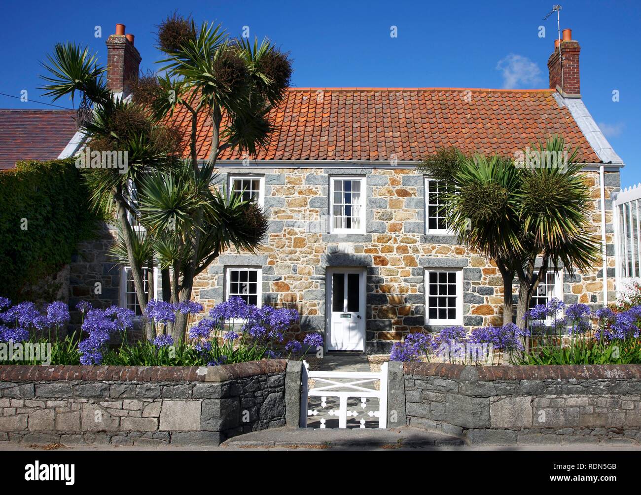 Typical Guernsey house made from solid stone and granite, with many