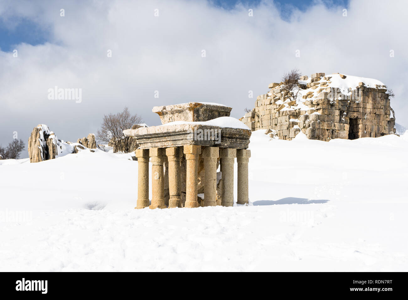 Tower of Caudius and the small altar covered in snow during winter, Faqra Roman ruins, Lebanon Stock Photo