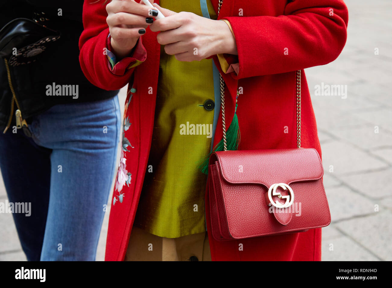 MILAN, ITALY - JANUARY 12, 2019: Woman with red Gucci leather bag and coat  before Frankie Morello fashion show, Milan Fashion Week street style Stock  Photo - Alamy