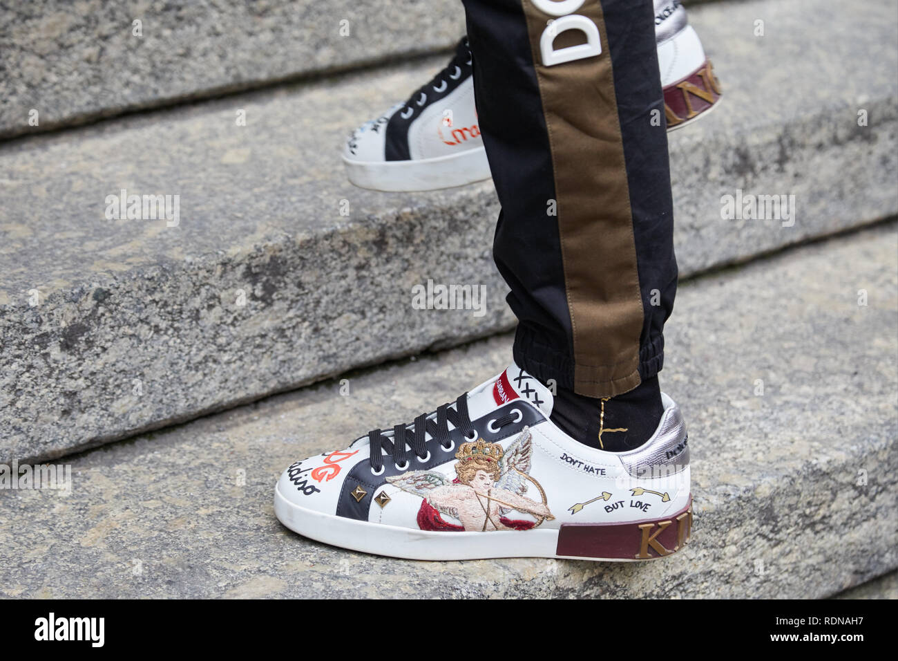 MILAN, ITALY - JANUARY 12, 2019: Man with Dolce and Gabbana sneakers with  Cupid before Frankie Morello fashion show, Milan Fashion Week street style  Stock Photo - Alamy