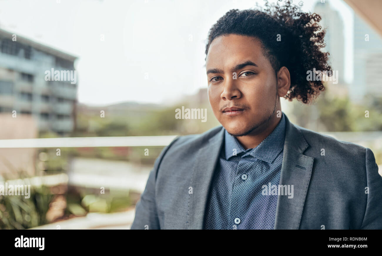 Young Confident Mixed Race Guy With Curly Afro Looking Into The