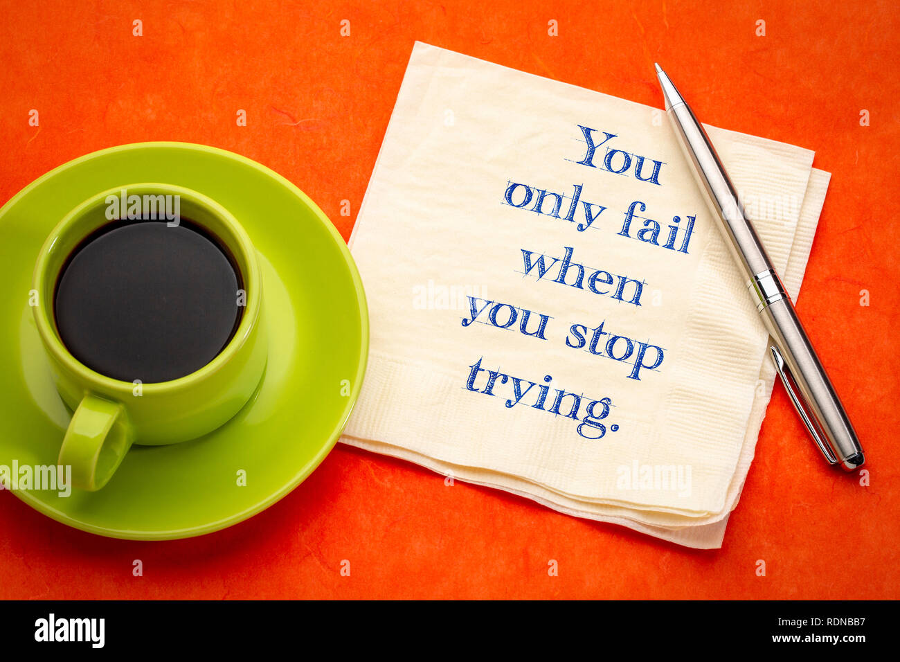You only fail when you stop trying - inspirational handwriting on a napkin with coffee Stock Photo