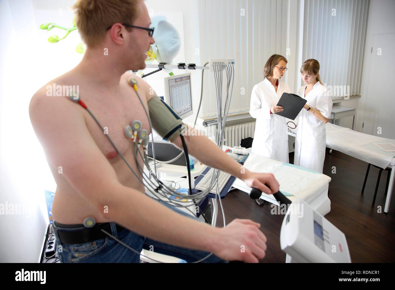 Medical practice, stress ECG, test to measure the cardiac function of a patient on a cardio machine Stock Photo
