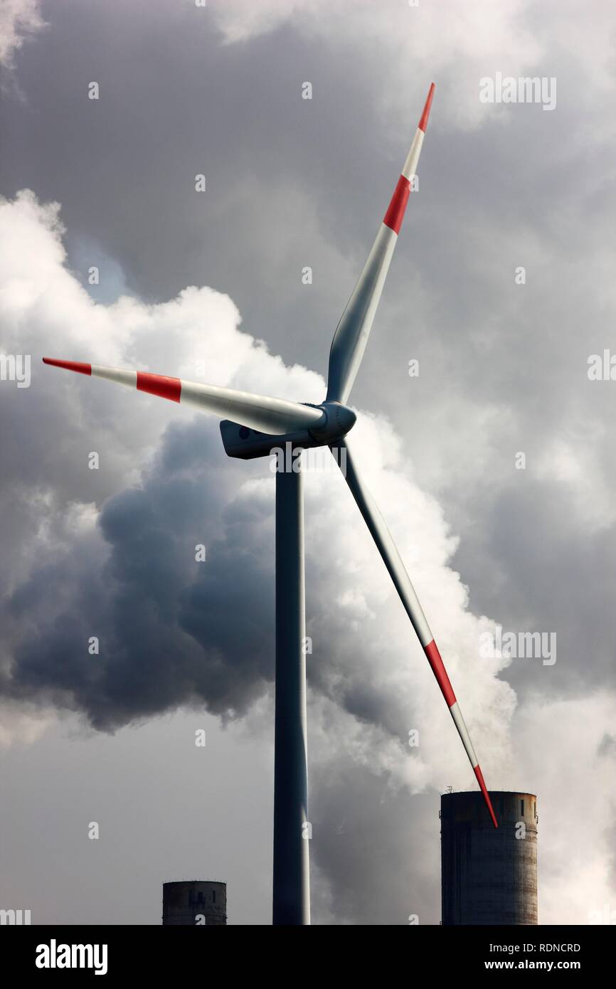Wind energy plant and smokestacks of a lignite power plant at Titz, coal mining area in the Lower Rhine, North Rhine-Westphalia Stock Photo