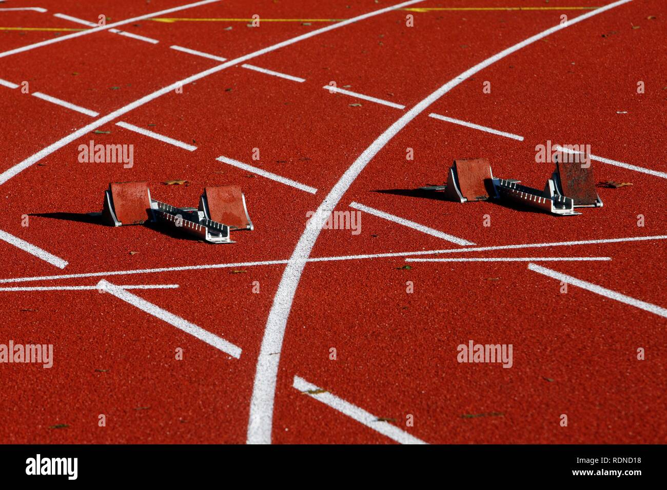 Tartan track of a sports field, starting blocks for sprinting