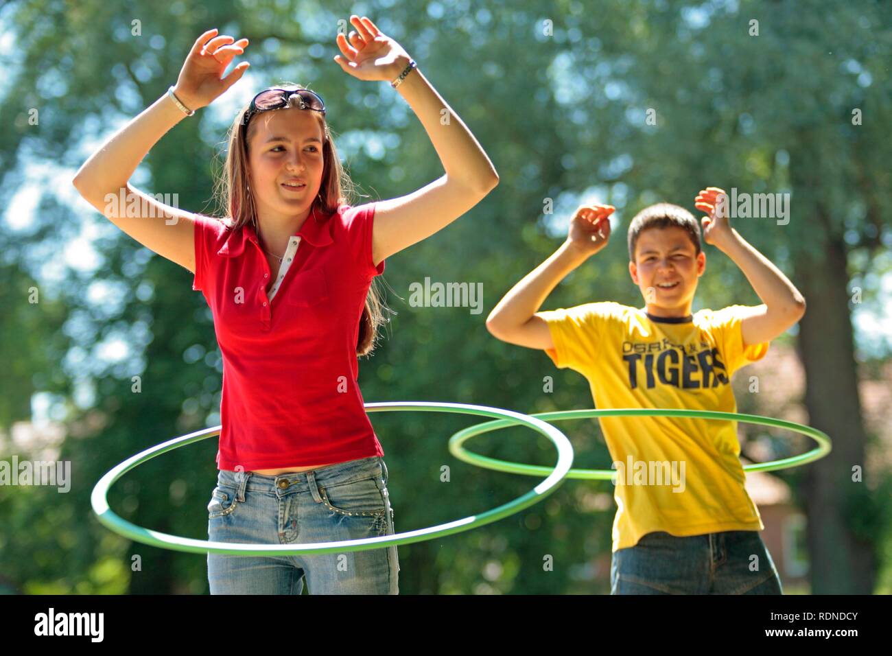 Teenagers using hula-hoops Stock Photo