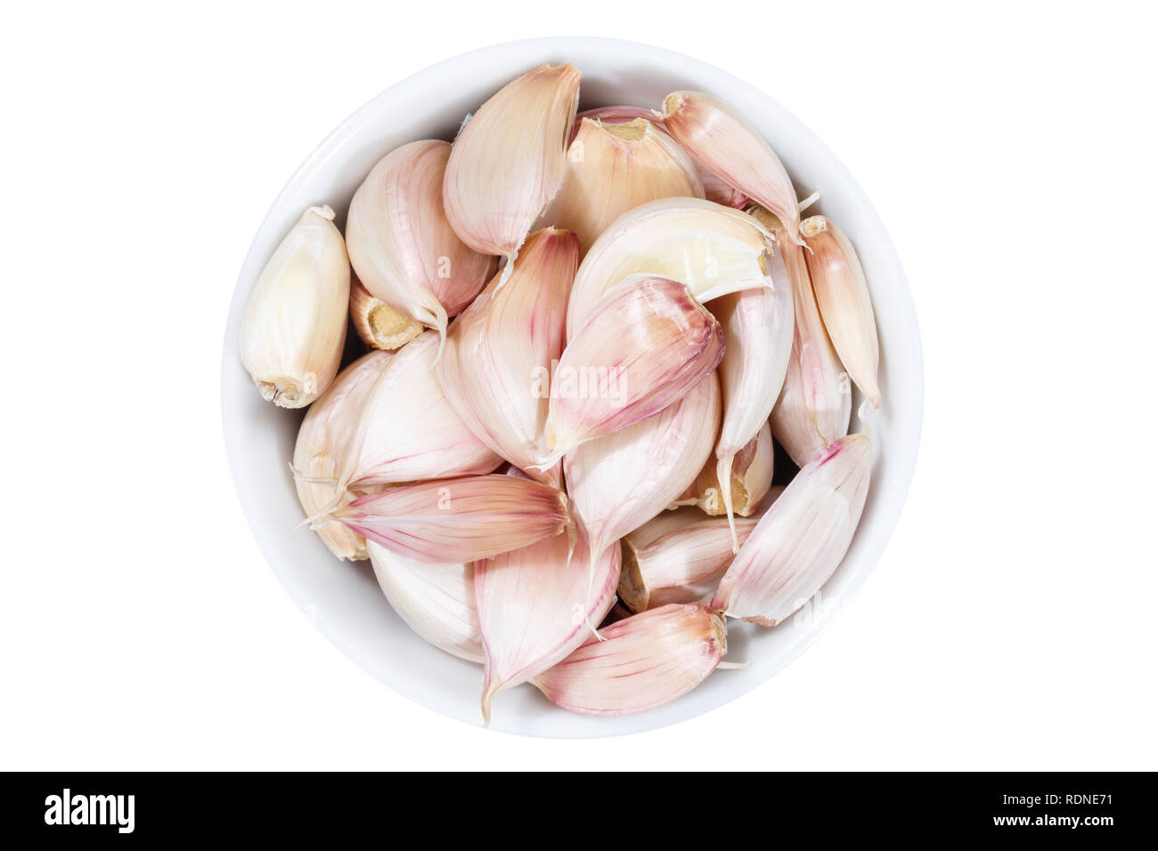 Garlic cloves from above bowl isolated on a white background Stock Photo