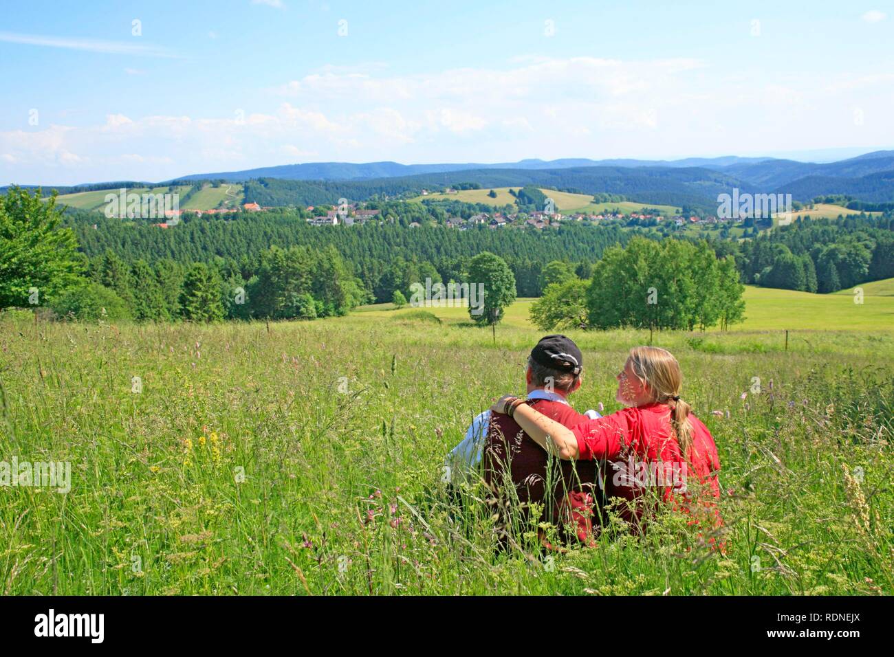 Couple enjoying the view towards Sankt Andreasberg, Harz, Lower Saxony Stock Photo