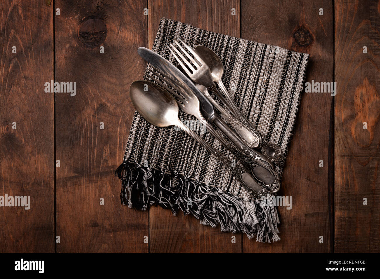 Top view of old silver cutlery on wooden table Stock Photo